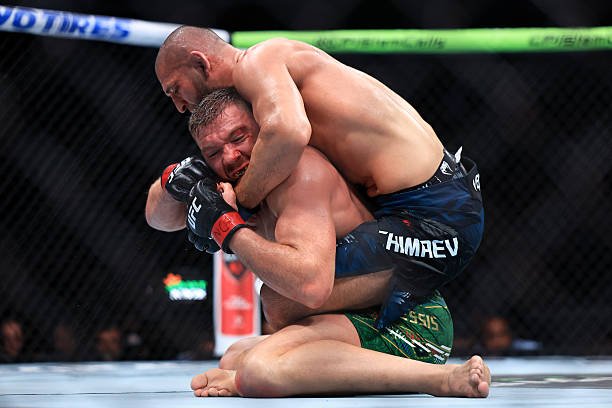 Khamzat Chimaev grapples with Dricus du Plessis during their middleweight title bout in UFC 319